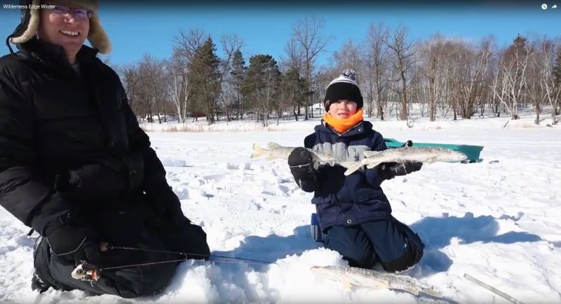 Fishing through the ice on the river