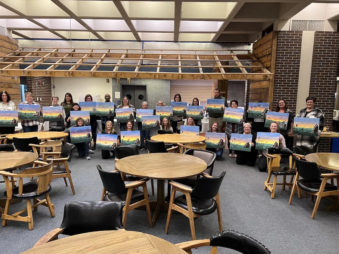 Finished paintings being shown off at paint night